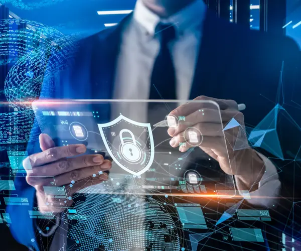 Businessman holding a tablet displaying a security symbol, representing IT infrastructure and security solutions