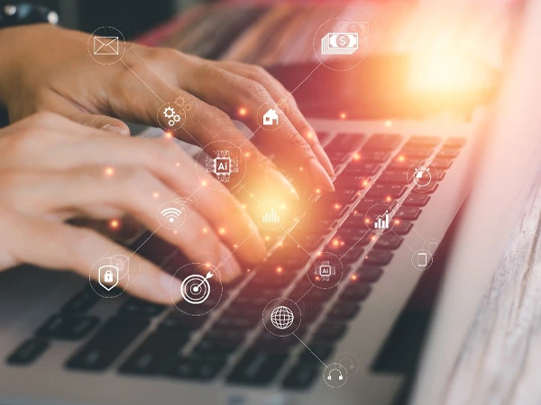 Businesswoman working on a laptop displaying various social media icons on the screen.