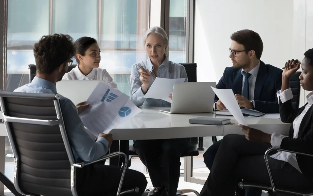 Business team reviewing financial documents in a meeting, representing financial operations, data security, and business continuity