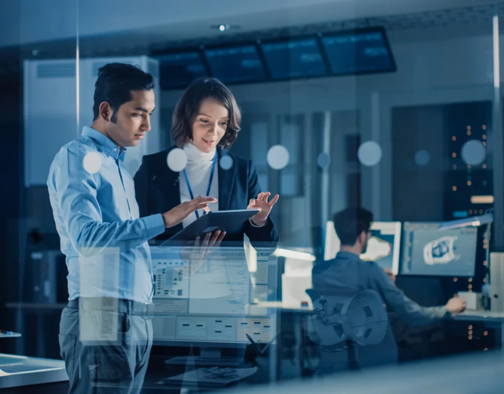 Professionals collaborating with a tablet in a modern tech office