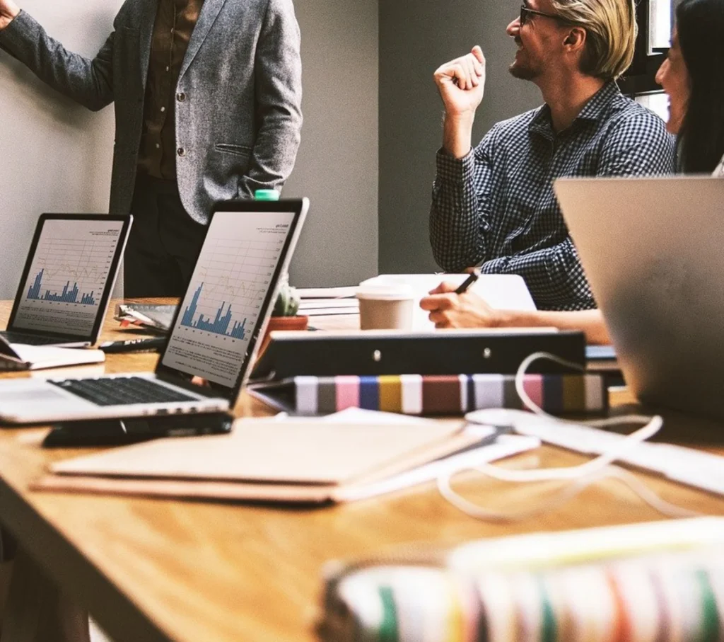 ZechionIT professionals in a meeting reviewing data, representing experience and origins in IT services