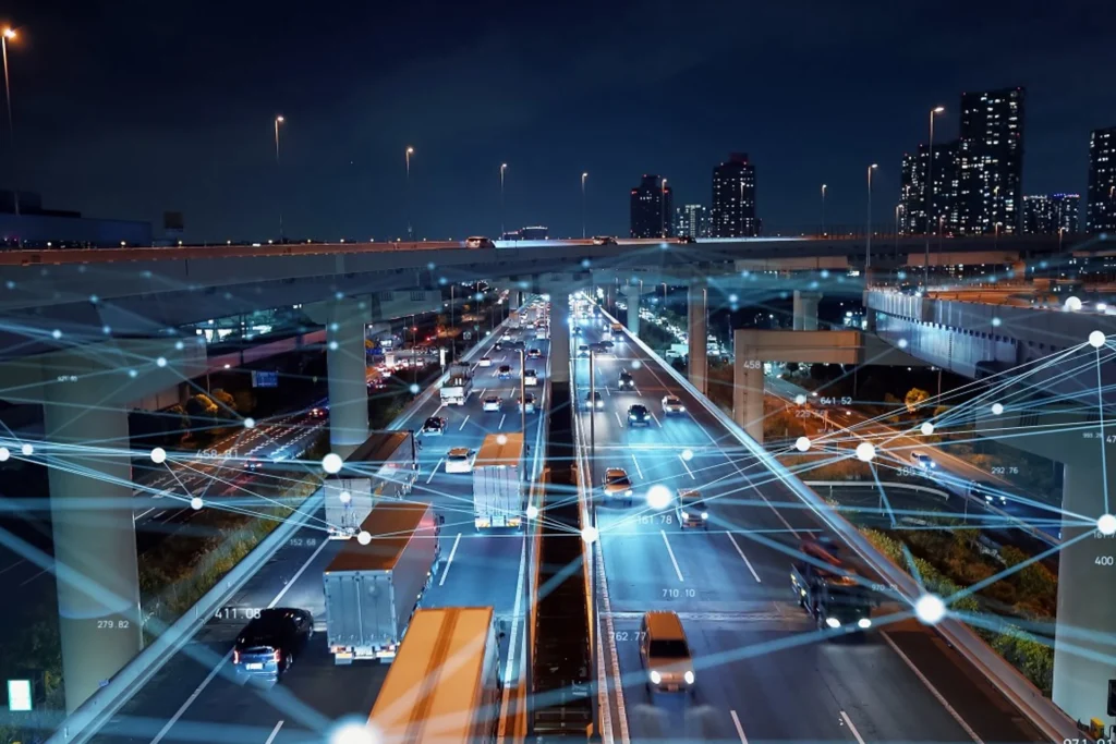 City skyline illuminated with connected lines and traffic, highlighting the theme of Software-Defined Vehicles and cybersecurity