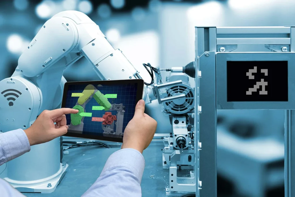 Individual with a tablet facing a robot, showcasing improvements in manufacturing efficiency