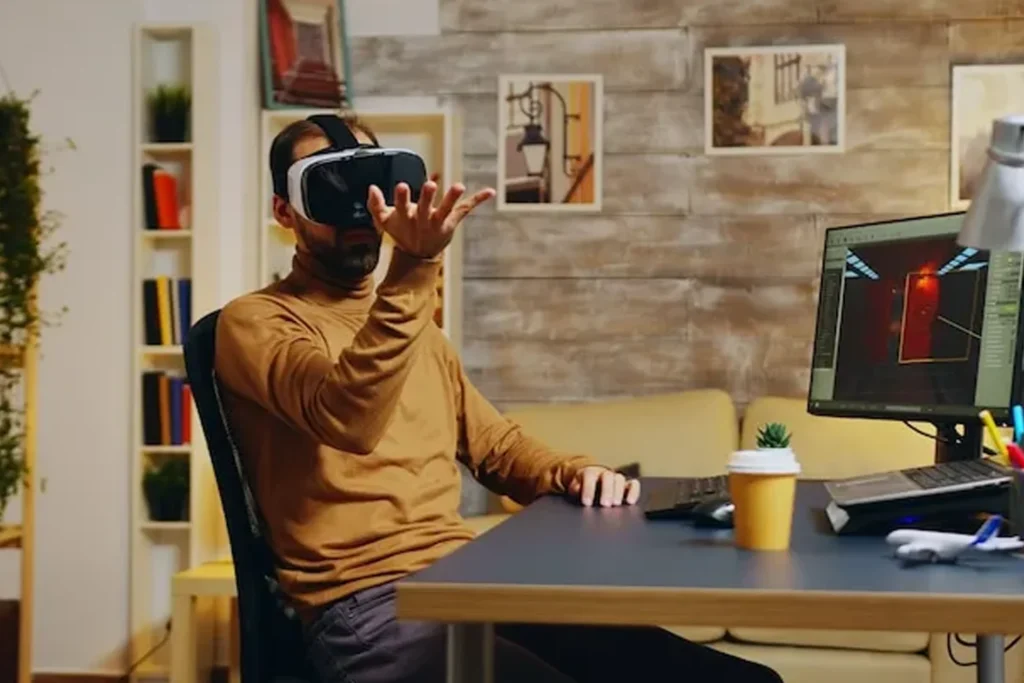 Man at his desk wearing a virtual reality headset, engaged in AR:VR and Metaverse game development