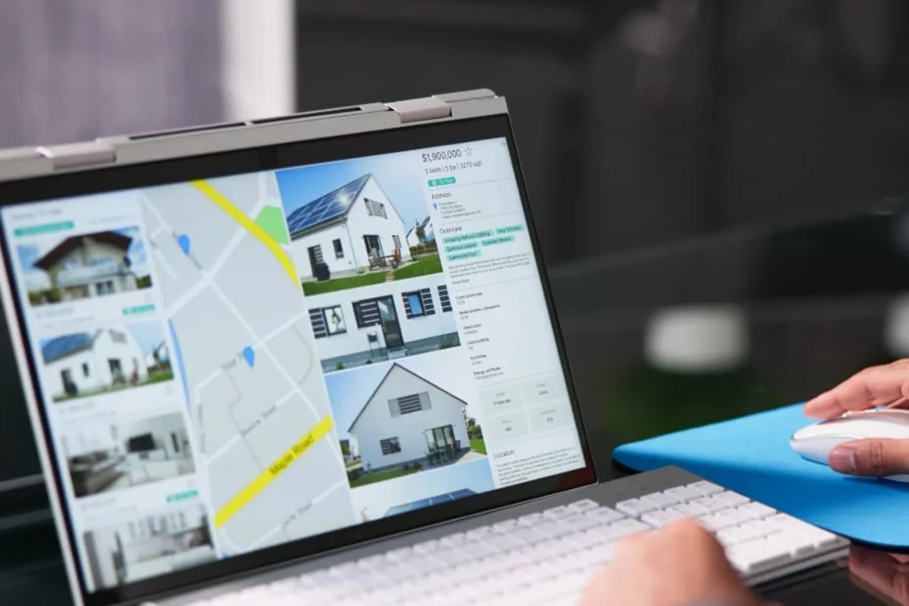 Man using a laptop to browse houses on the internet, utilizing AI-driven property suggestions