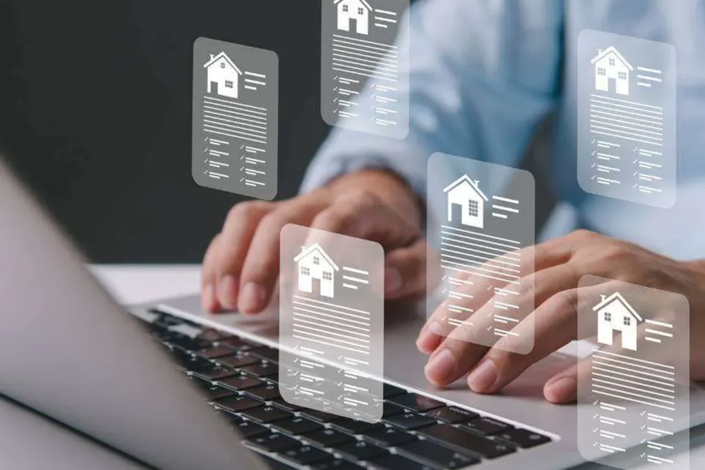 Person types on a laptop displaying a house icon, representing Smart Property & Portfolio Management