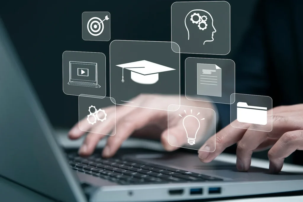 Person types on a laptop displaying various icons, representing a Flexible Learning Management System (LMS)