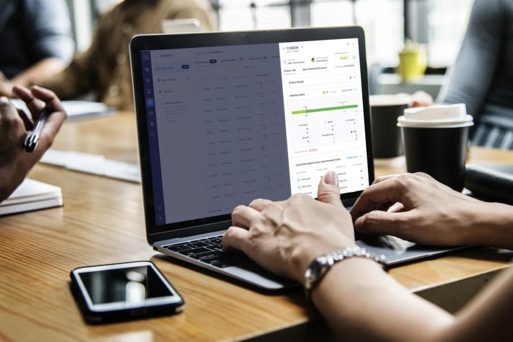 Person working on a laptop displaying a web page about comprehensive product and inventory management