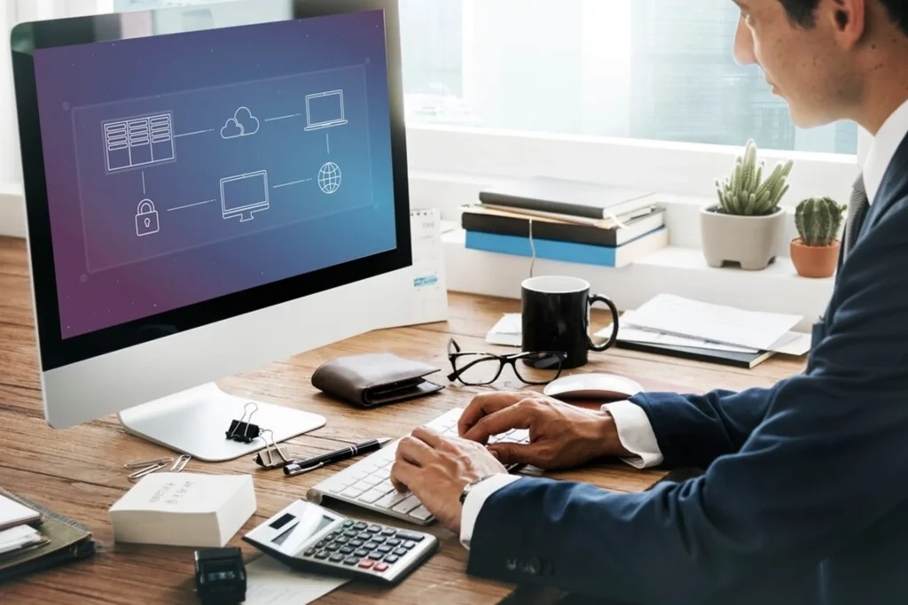 Suited man working intently on a computer, illustrating tailored solutions for large organizations