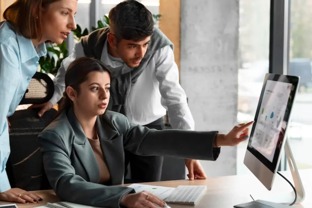 Team members engaged in a computer task in an office, exploring flexible engagement models