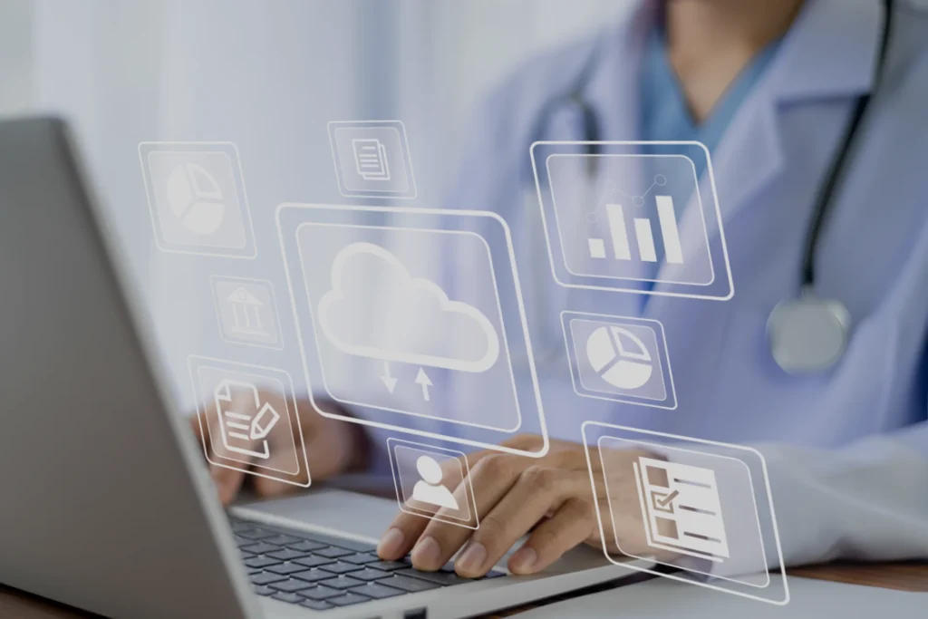 Woman in a lab coat is focused on typing on a laptop with healthcare icons, representing secure cloud solutions
