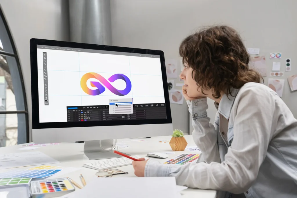 Woman observes a computer screen featuring an animated infinite logo, showcasing dynamic and interactive branding